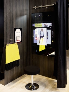 Bis der Kunde die Kabine betritt, spielt der verspiegelte Touch-Bildschirm des „Interactive Fitting Room“ Digital-Signage-Inhalte aus. (Foto: <a href=