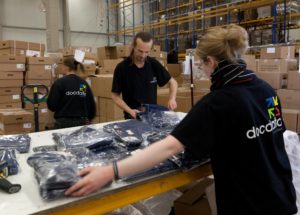 Fachkundige Mitarbeiter der Docdata Fashion Services GmbH kommissionieren die einzelnen Kleidungsstücke und fügen Teilbestellungen zu einer Sammelbestellung zusammen.